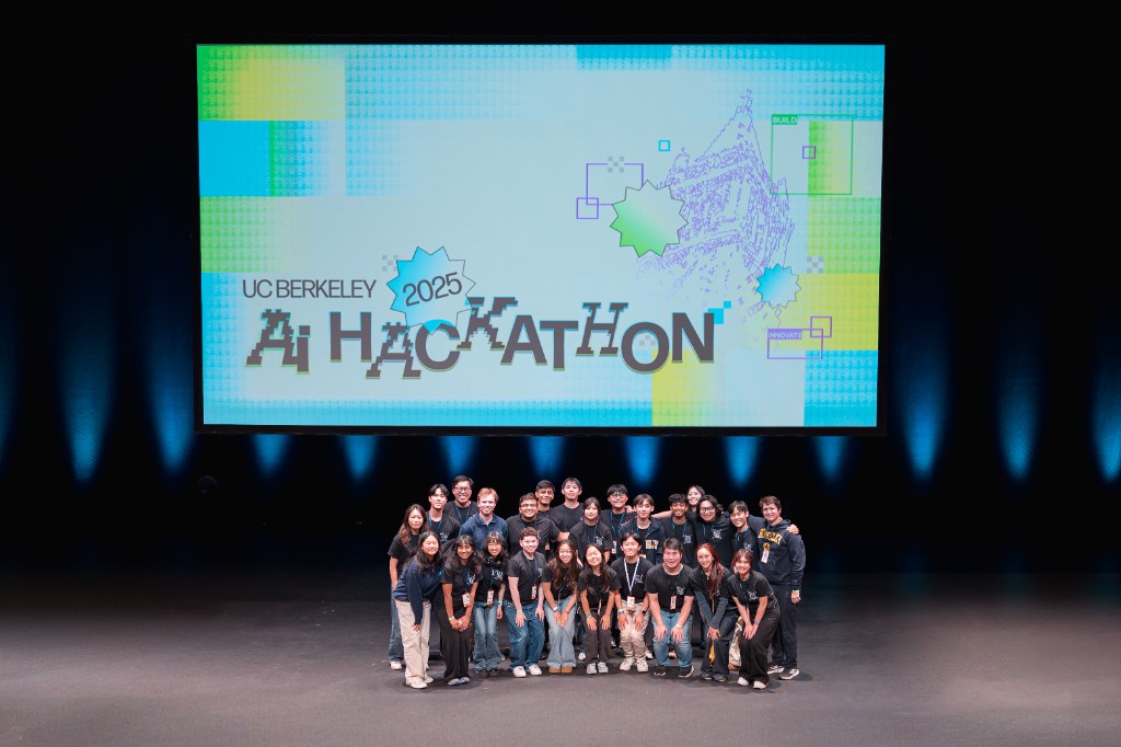 The AI Hackathon 2025 team on stage in front of the UC Berkeley AI Hackathon screen