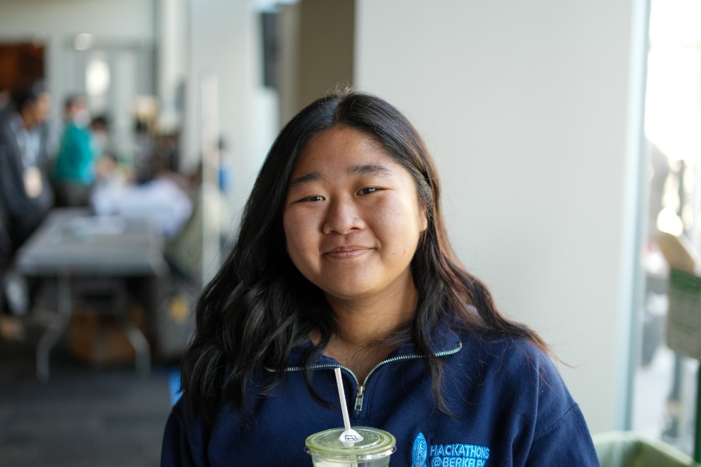 Flora holding a boba during a hackathon