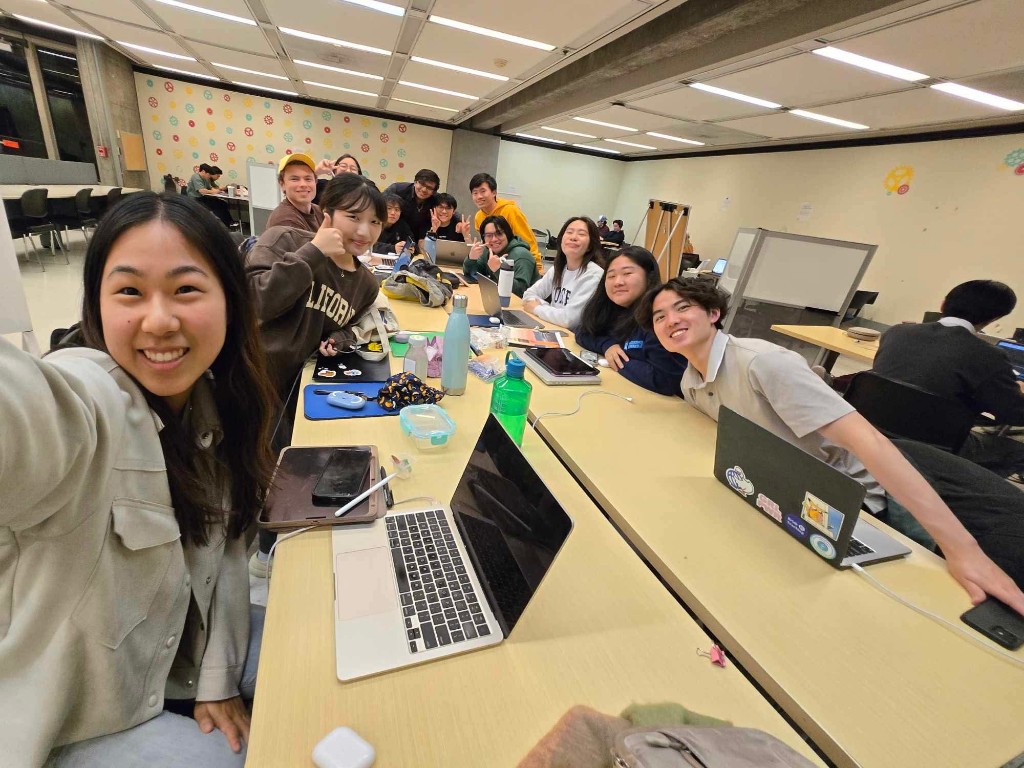 A team selfie at the hacking tables late at night