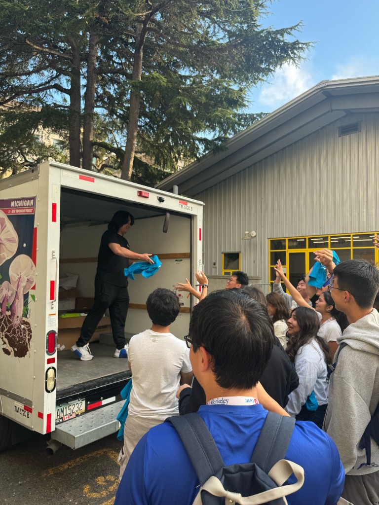 Tossing t-shirts from a truck to a crowd of students