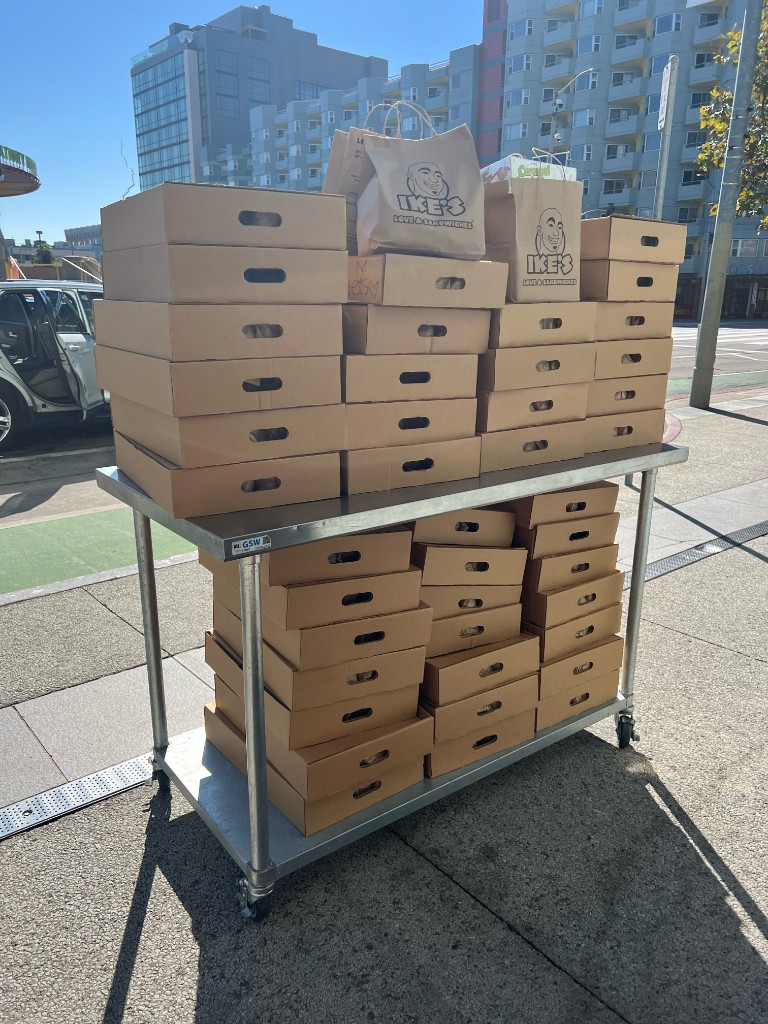 A cart stacked with boxes of Ike's sandwiches for Cal Hacks 10.0