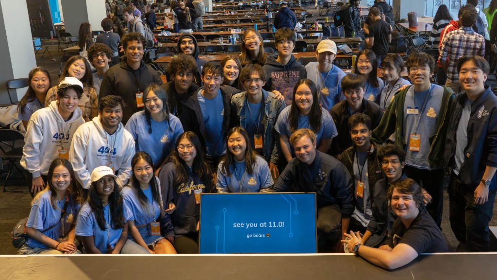 The Cal Hacks 10.0 team posing in front of a 'see you at 11.0!' screen